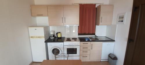 a small kitchen with a stove and a sink at Villa Molivos Castle in Mithymna