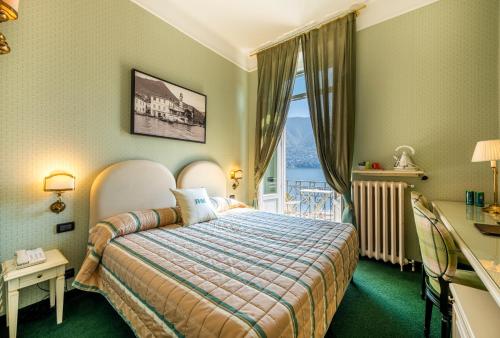 a hotel room with a bed and a window at Hotel Miralago in Cernobbio