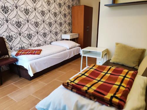a hotel room with two beds and a table at OWR Kamyczek in Sarbinowo