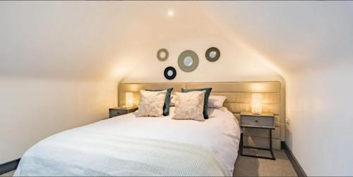 a bedroom with a large white bed with two night stands at Little Seven Oaks in Langley