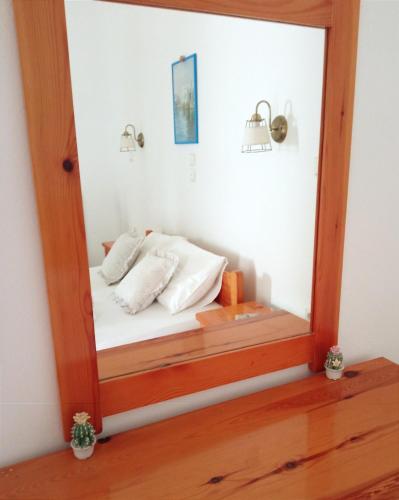 a mirror with a bed in a room at Katerina Studios in Naxos Chora