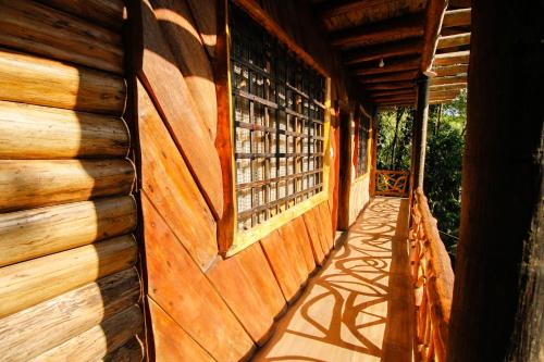 a hallway of a wooden house with a window at Hosteria Flor de Canela in Puyo