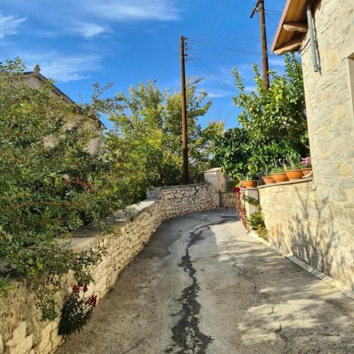 a stone alley way with a stone wall at The Stonehouse Suites with Private Bath Spas in Limassol