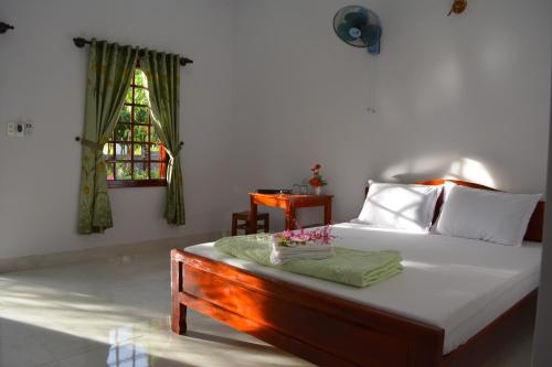 Säng eller sängar i ett rum på Diem Lien Guesthouse