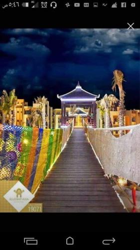 a boardwalk leading up to a gazebo with a gazeb at Blue Bay Asia Sokhna Aqua park بلو باي اسيا العين السخنه - عائلات فقط in Ain Sokhna