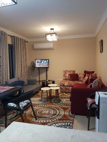 a living room with a couch and a table at Blue Bay Asia Sokhna Aqua park بلو باي اسيا العين السخنه - عائلات فقط in Ain Sokhna