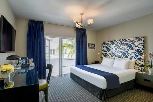 a hotel room with a bed and a balcony at Hotel Breakwater South Beach in Miami Beach