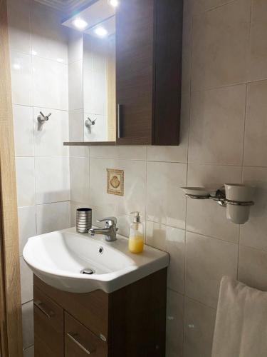 a bathroom with a sink and a mirror at Seaside Villa in Nea Potidaea