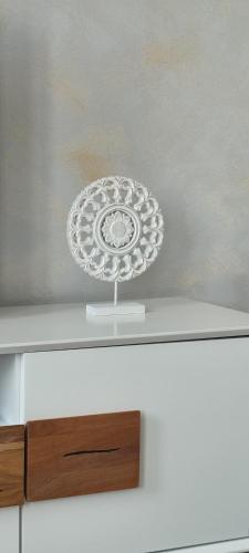 a silver plate on top of a white shelf at Apartmán maxi - Café Princ pod hradem KLIMA, WiFi in Šternberk
