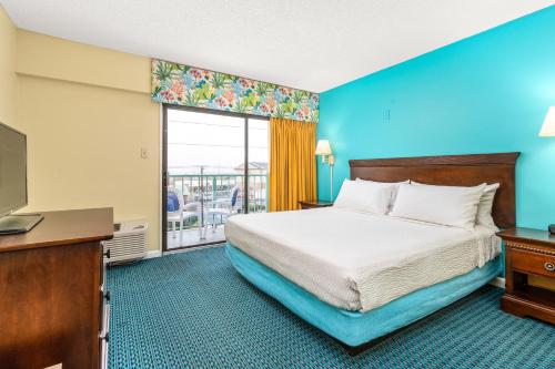 Ένα ή περισσότερα κρεβάτια σε δωμάτιο στο Cayman Suites Hotel
