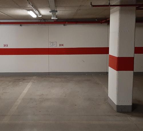 a garage with a red and white wall at Appartamento Zeni - Dolomiti di Brenta in Molveno