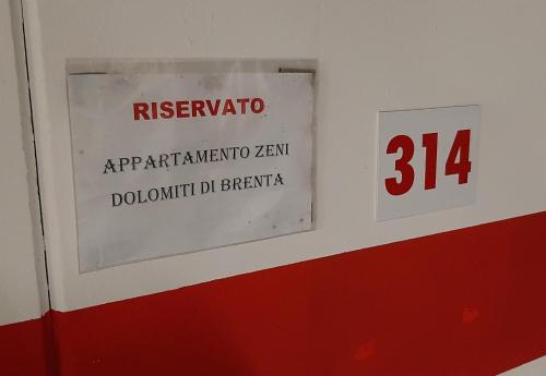 a sign on a wall with the number at Appartamento Zeni - Dolomiti di Brenta in Molveno
