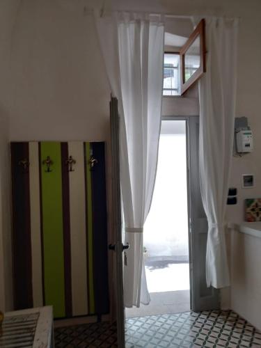 a room with an open door to a bedroom at Mèna Mè - Casa vacanza - Salento in Parabita