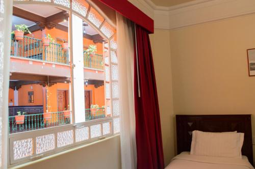 a window in a room with a bed and a window sill at Best Western Majestic in Mexico City