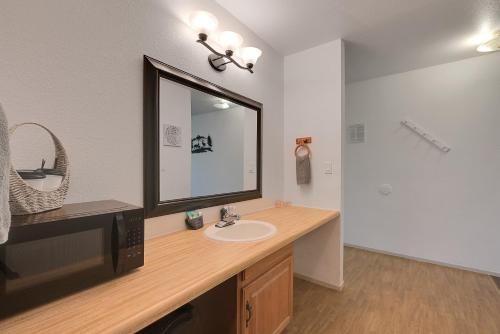 a bathroom with a sink and a mirror at Brownsville Motel in Brownsville