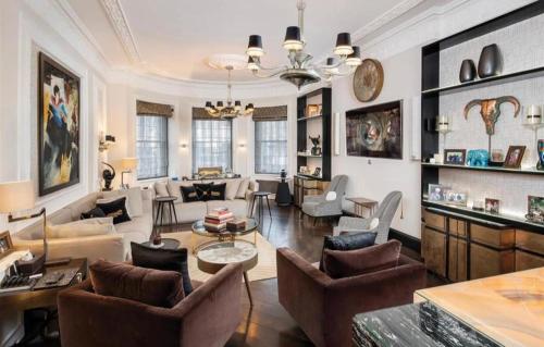 a living room filled with furniture and a chandelier at 6000sqft Apartment on Park Lane with Private Swimming pool,Gym&Sauna in London