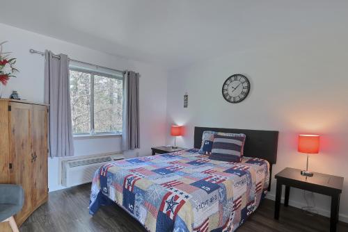 a bedroom with a bed and a clock on the wall at Brownsville Motel in Brownsville
