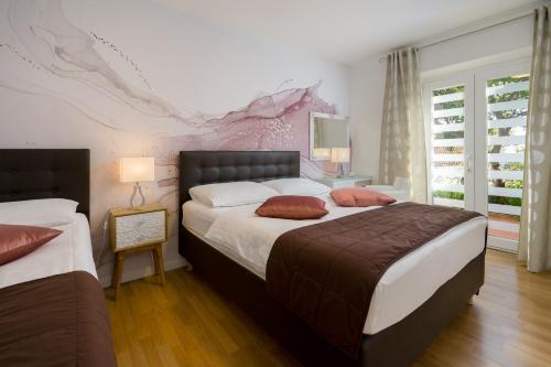 Postel nebo postele na pokoji v ubytování Apartments Zicara