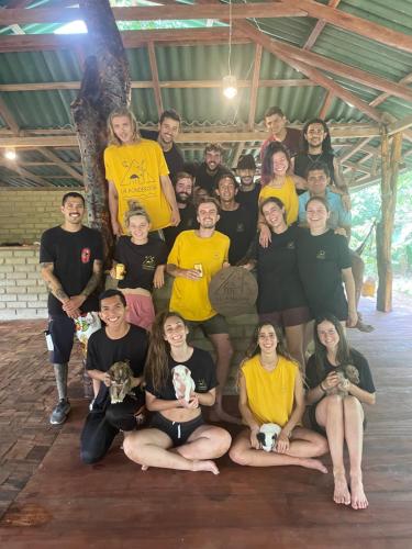 a group of people are posing for a picture at La Ponderosa Reserve in Buritaca