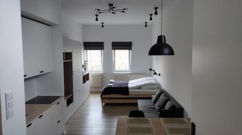 a bedroom with white walls and a bed in a room at Apartament 4 Piętro in Sopot