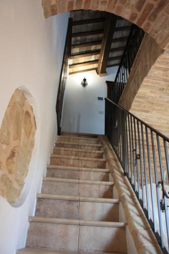 a staircase in a house with wooden ceilings at ANPEMO Casa Vacanze dimora storica dal 1837 in Silvi Paese