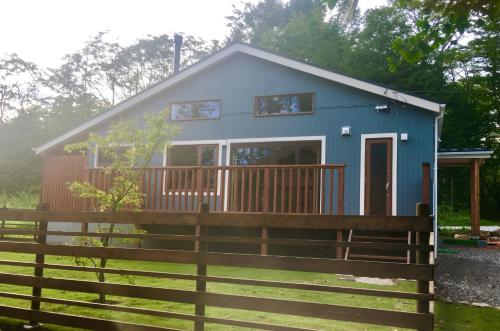 a blue tiny house with a wooden fence at DAISHO - Vacation STAY 36303v in Hokuto