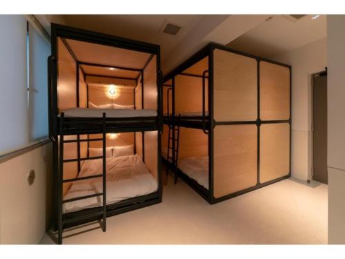 a room with two bunk beds in a room at Kamon Hotel Namba - Vacation STAY 37041v in Osaka