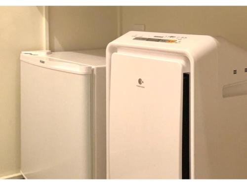 a white refrigerator next to a small freezer at Kamon Hotel Namba - Vacation STAY 37041v in Osaka