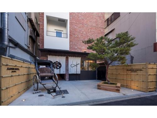 a chair sitting on a sidewalk in front of a building at Kamon Hotel Namba - Vacation STAY 37041v in Osaka