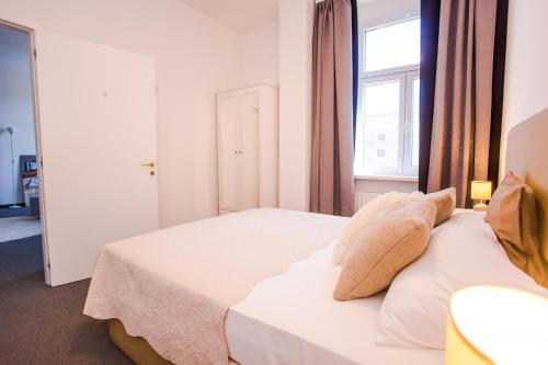 a bedroom with two beds and a window at Apartments DOLAC Zagreb in Zagreb