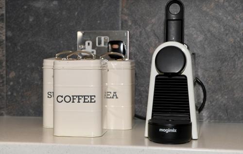 a coffeemaker and a coffee maker sitting on a counter at Garden Mews - 2 double bedrooms - Harrogate Holiday Apartments in Harrogate