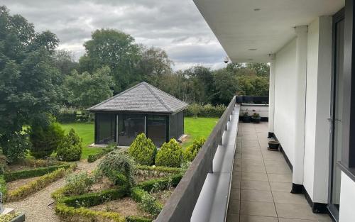 a balcony with a gazebo in a garden at Hazelwood Country House in Adare