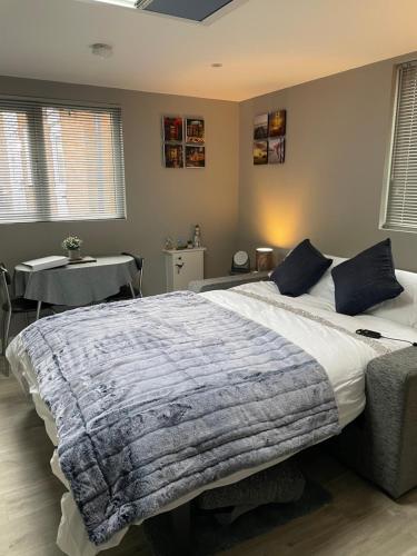 a bedroom with a large bed and a table at Lytham Sea Salt Lodge in Lytham St Annes