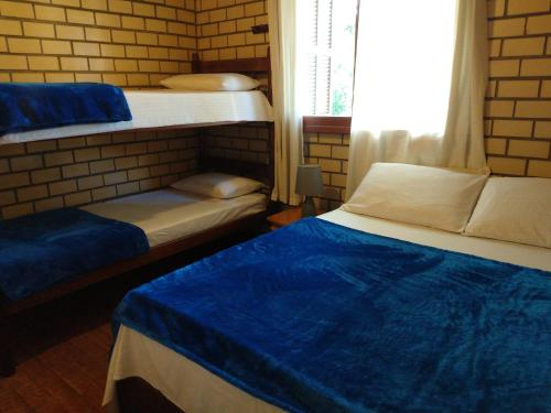 A bed or beds in a room at Morada Quatro Elementos