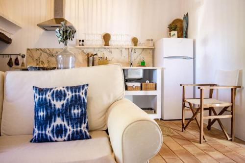 a living room with a couch and a refrigerator at Monte Alentejano - Melides in Melides