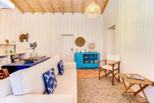 a living room with a white couch and a table at Monte Alentejano - Melides in Melides