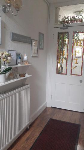 a room with a white door and a window at Marjune Guest House in Weymouth
