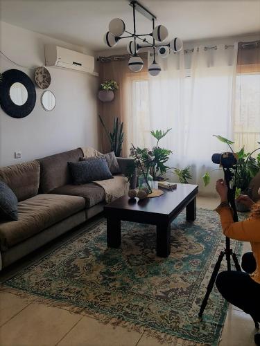 a living room with a couch and a coffee table at Rotem Home in Haifa