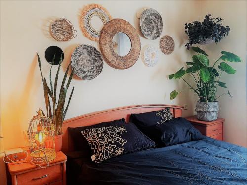 a bedroom with a bed and some plates on the wall at Rotem Home in Haifa