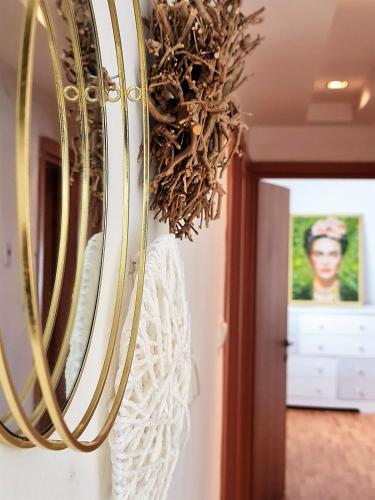 a mirror hanging on a wall in a room at Rotem Home in Haifa