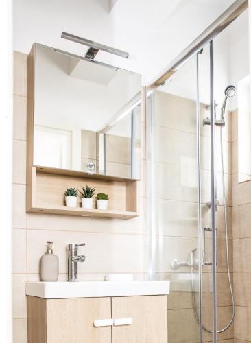 a bathroom with a sink and a shower at Boho Blu by A&D Properties in Porto Rafti