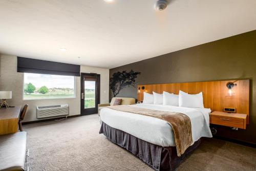 a hotel room with a large bed and a window at Red Sands Hotel in Torrey