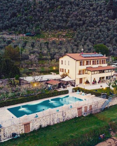 an aerial view of a house with a swimming pool at Sotto il cielo di Toscana appartamenti in tenuta only adults no pet in Camaiore