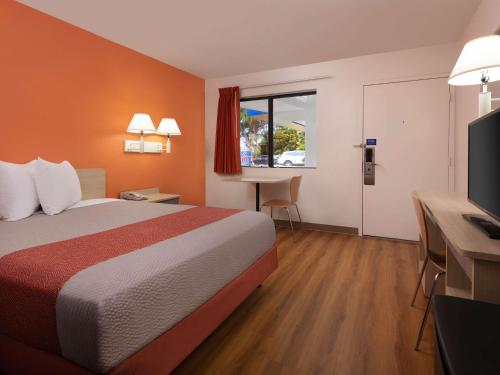 a hotel room with a bed and a desk at Motel 6-Santa Maria, CA - North in Santa Maria