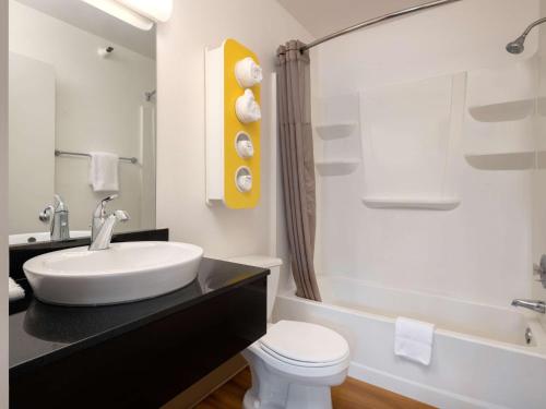 a bathroom with a sink and a toilet and a tub at Motel 6-Santa Maria, CA - North in Santa Maria