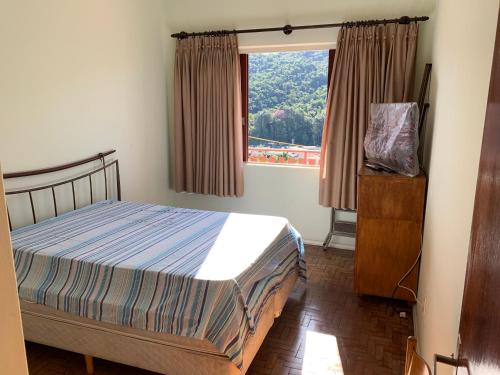 a bedroom with a bed and a window at Apart 1 Dorm Sala 3 Ambientes in Águas de Lindoia