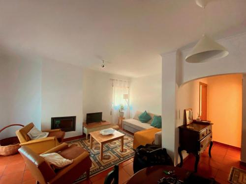 a living room with a couch and a table at CASAS NAS TERMAS in Cabeço de Vide