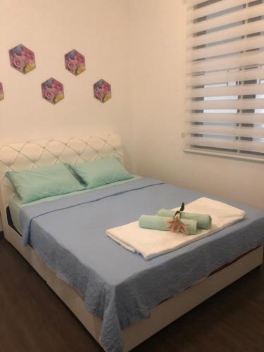 a bedroom with a bed with towels on it at EasyOne Homestay@Vista Bangi in Kajang