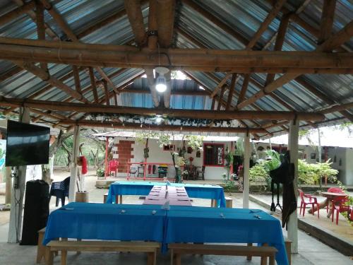 a group of blue tables in a pavilion at Finca Ecoturistica LOS JAGUEYES in Baraya