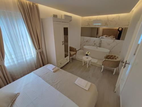 a bedroom with a bed and a tub and a sink at Villa Vista Real in Kotor
